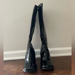 High black gloss high heeled boots.